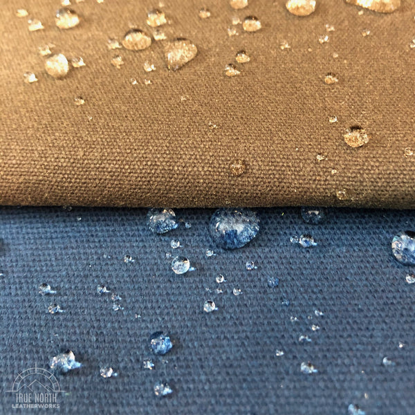 water droplets beaded up on samples of brown and blue waxed canvas